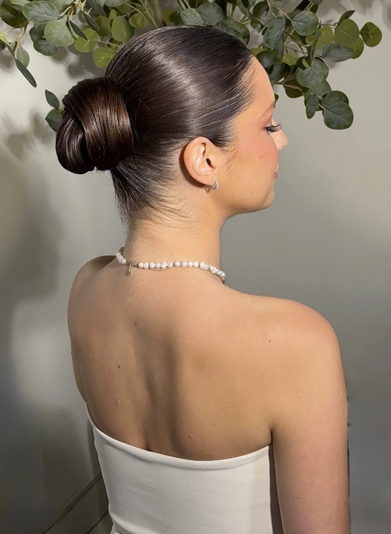Polished low bun styled for a classic, timeless bridal look