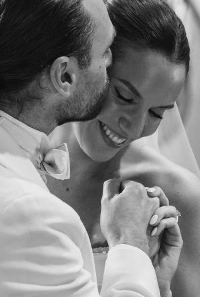 Intimate moment between bride and groom, black and white